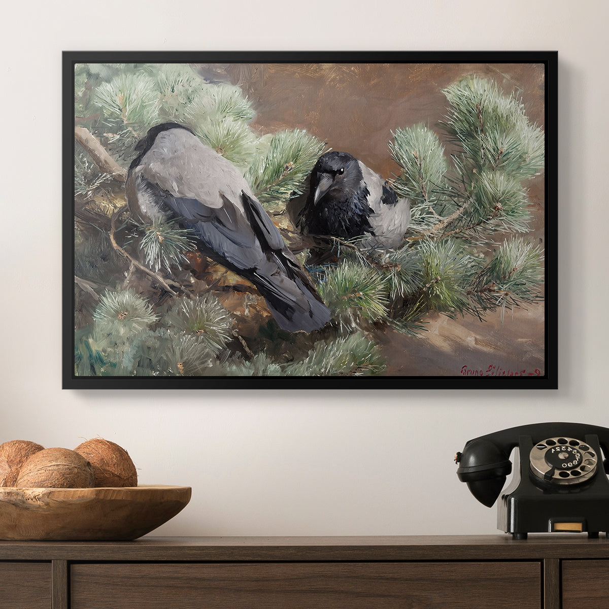 Hooded Crows (Kråkor), 1891 by Bruno Liljefors in a black floater framed canvas displayed above a console table in a hallway, featuring a wildlife painting of dark birds against muted landscape.