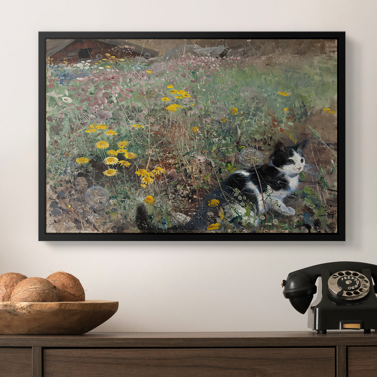 Cat on a Flowery Meadow, 1887 by Bruno Liljefors in a black floater framed canvas displayed above a console table in a hallway, featuring a naturalistic depiction of cat in blooming countryside setting.