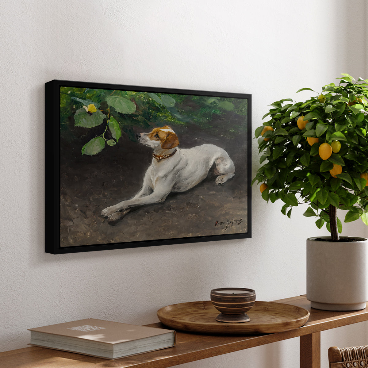 Portrait of a Dog, 1891 by Bruno Liljefors, presented in a black floater framed canvas featuring a dog lying on ground with head raised in natural outdoor setting, displayed above a hallway console table.