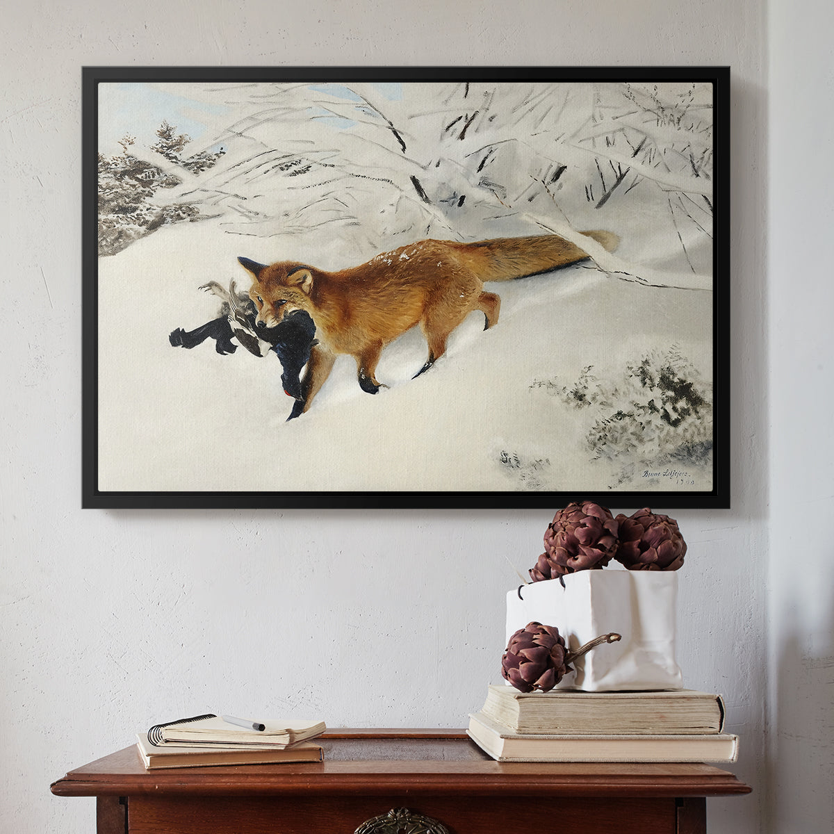 Black floater framed canvas featuring Fox in Snow Landscape, 1900 by Bruno Liljefors above an entryway table in a minimalist foyer.