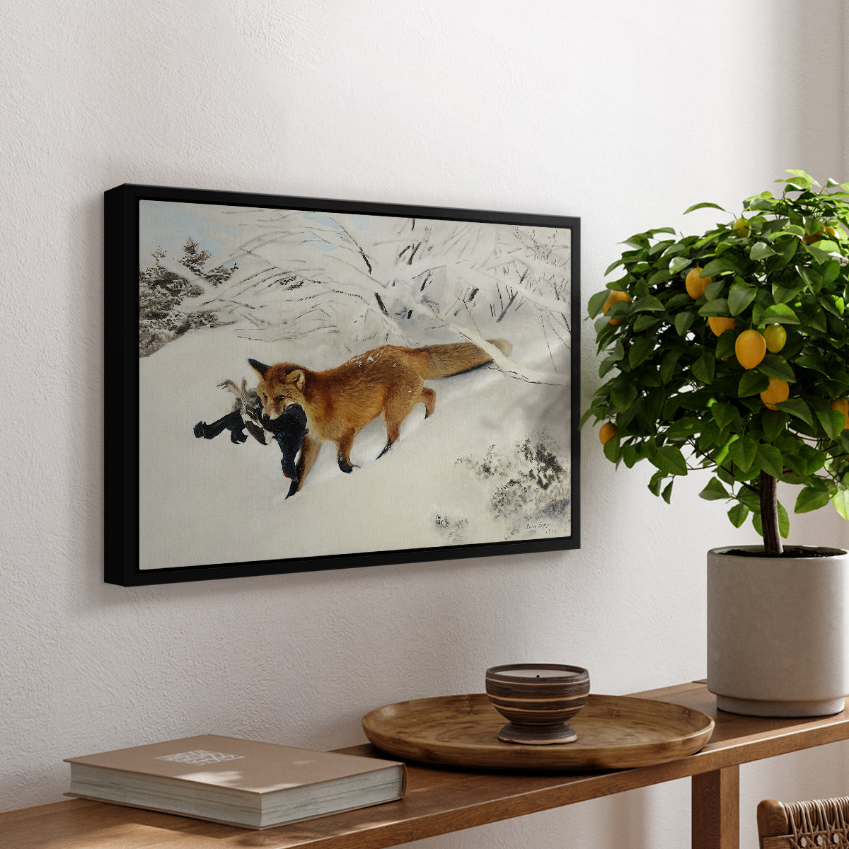 Fox in Snow Landscape, 1900 by Bruno Liljefors, presented in a black floater framed canvas featuring a fox running across snowy landscape with sparse vegetation, displayed above a hallway console table.