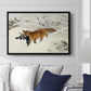 Fox in Snow Landscape, 1900 by Bruno Liljefors displayed above a sofa in a living room in a black floater frame, featuring a wildlife scene of fox moving swiftly through winter terrain.
