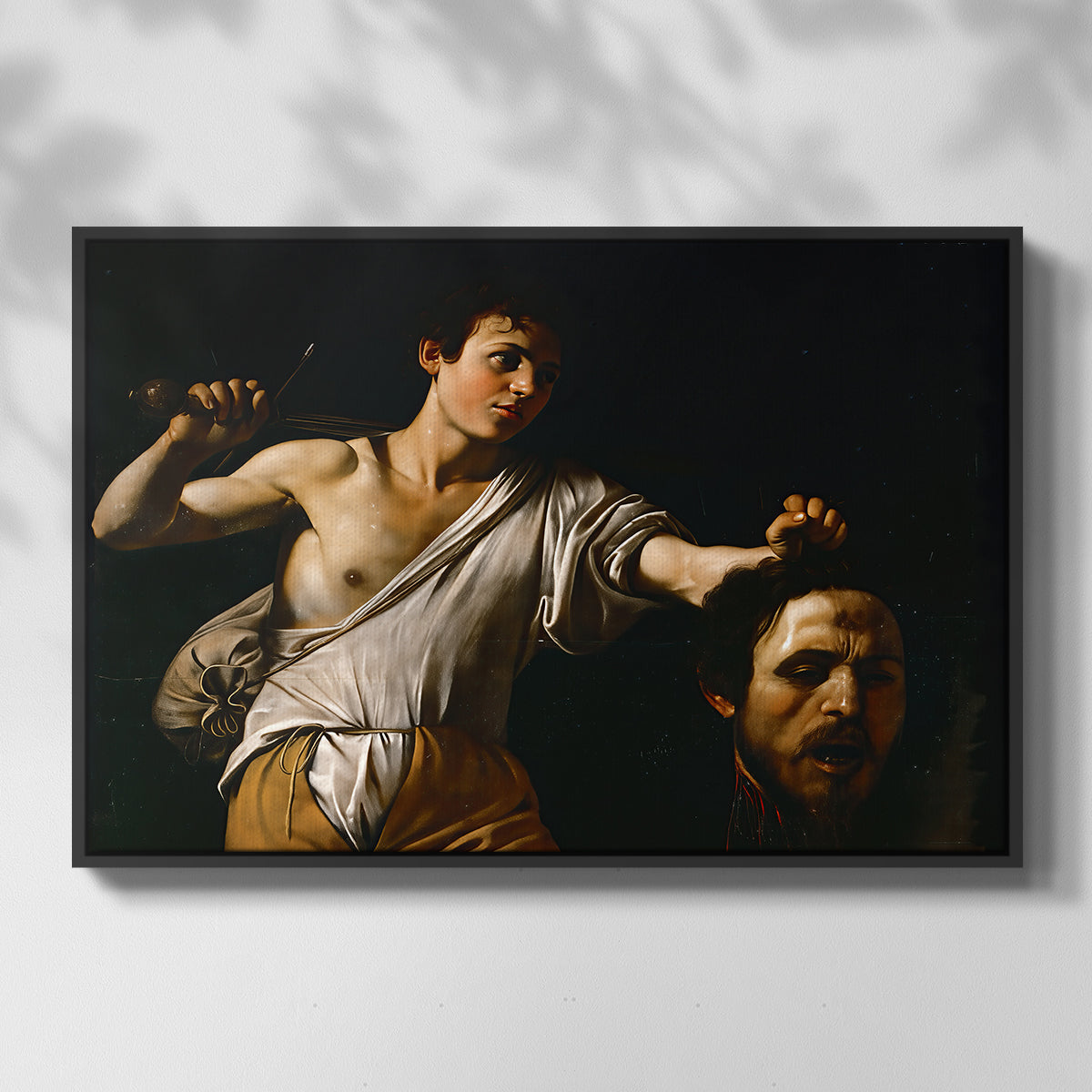Front view of David with the Head of Goliath (Vienna Version), c. 1607 by Caravaggio in a black floater framed canvas.