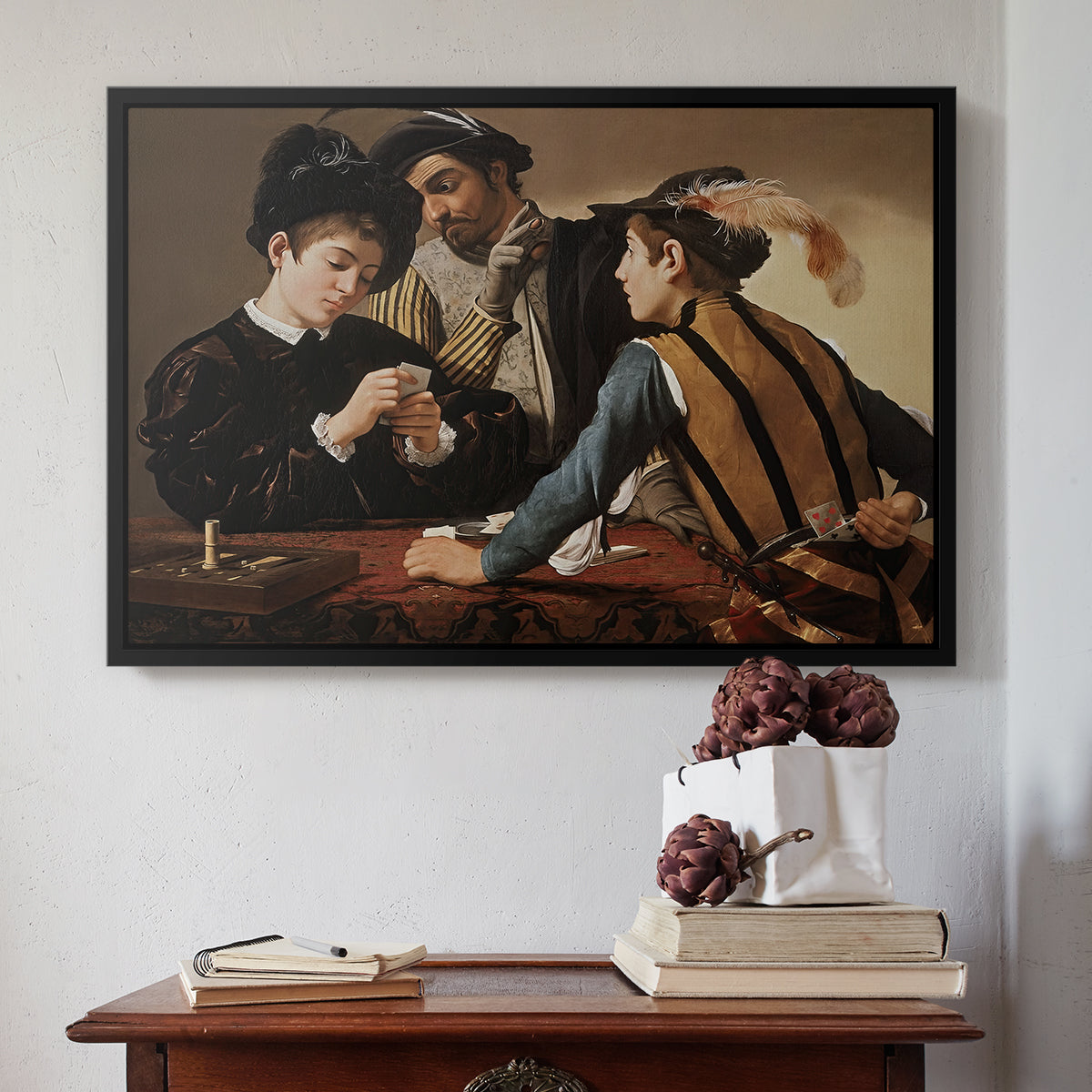 Black floater framed canvas featuring The Cardsharps, c. 1594 by Caravaggio above an entryway table in a minimalist foyer.