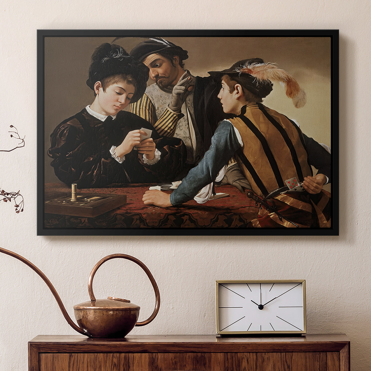 Black floater framed canvas featuring a young men playing cards with one cheating and another watching closely, displayed above a cabinet in a soft-toned living room.