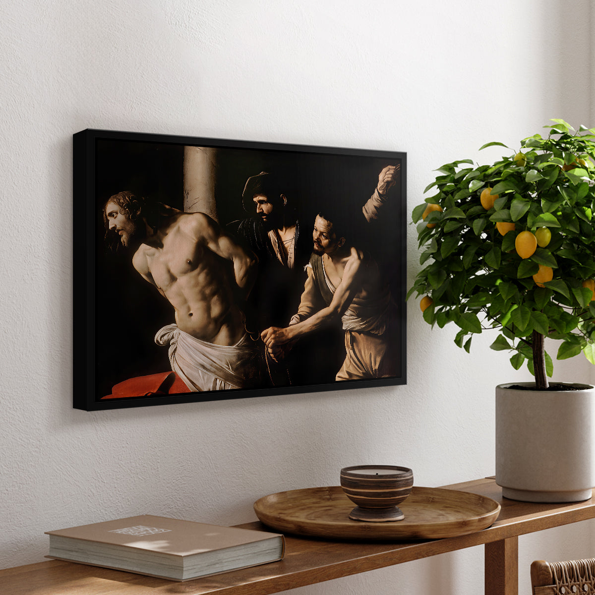 The Flagellation of Christ at the Column (Rouen Version), 1606 by Caravaggio, presented in a black floater framed canvas featuring Christ bound to column while being whipped by surrounding figures, displayed above a hallway console table.