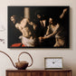Black floater framed canvas featuring a biblical depiction of men whipping Christ tied to pillar, displayed above a cabinet in a soft-toned living room.
