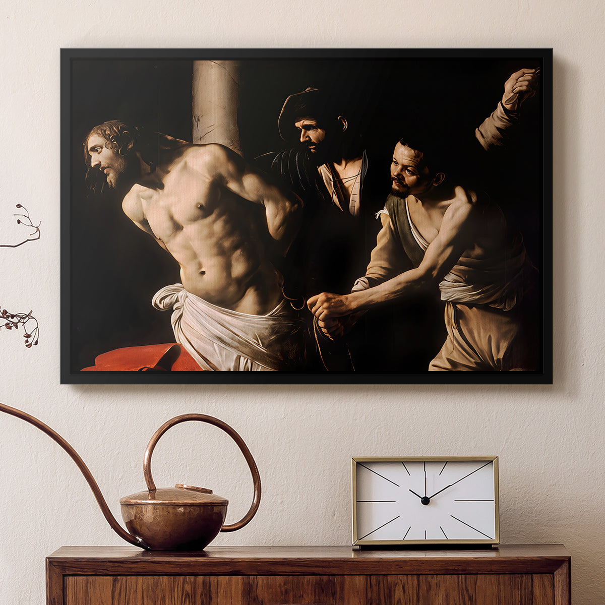 Black floater framed canvas featuring a biblical depiction of men whipping Christ tied to pillar, displayed above a cabinet in a soft-toned living room.