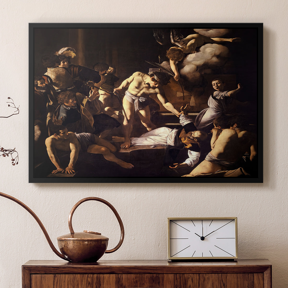 Black floater framed canvas featuring a religious narrative showing violent attack on saint in crowded setting, displayed above a cabinet in a soft-toned living room.