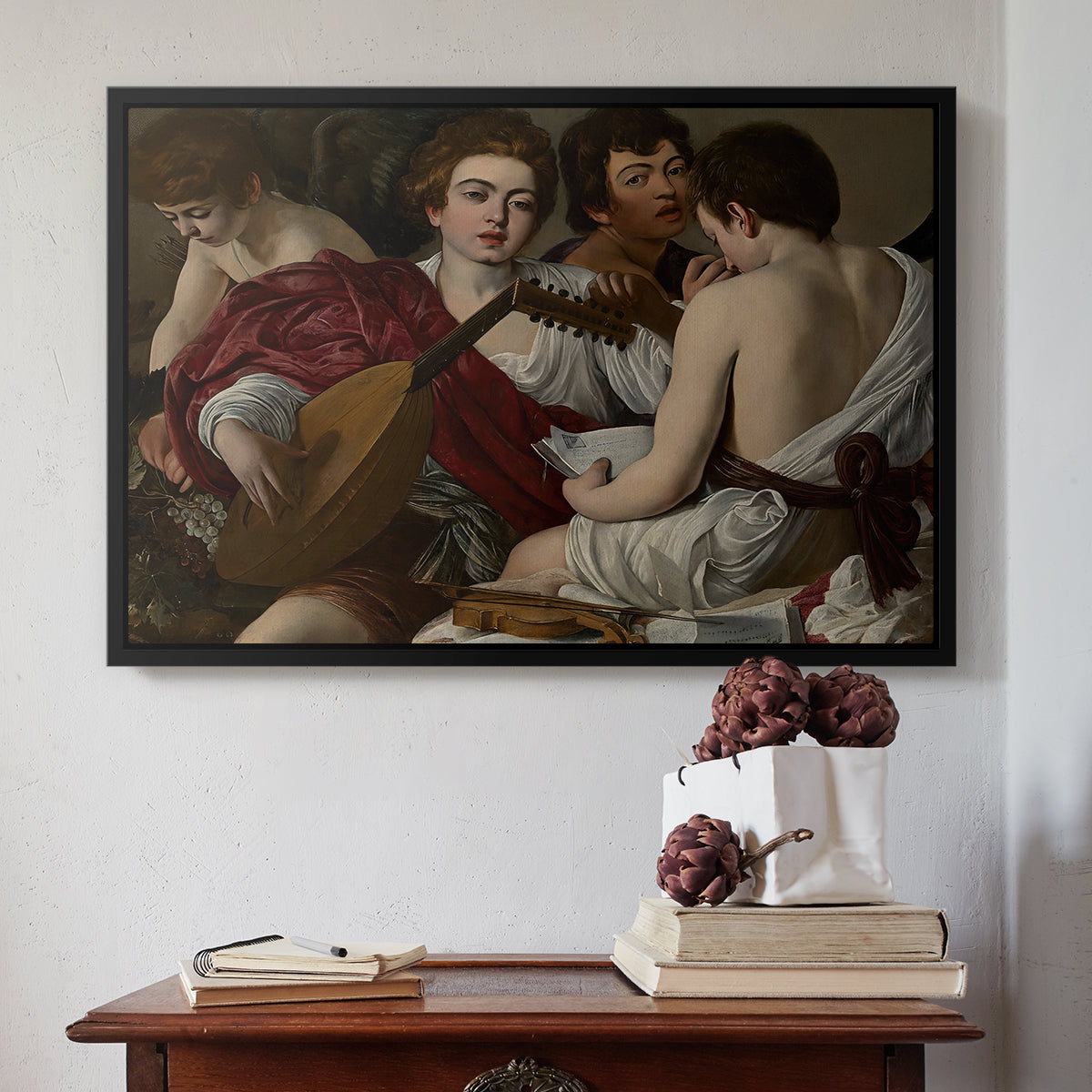 Black floater framed canvas featuring The Musicians, c. 1595 by Caravaggio above an entryway table in a minimalist foyer.