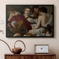 Black floater framed canvas featuring an intimate scene of youths making music with sheet music and instruments, displayed above a cabinet in a soft-toned living room.