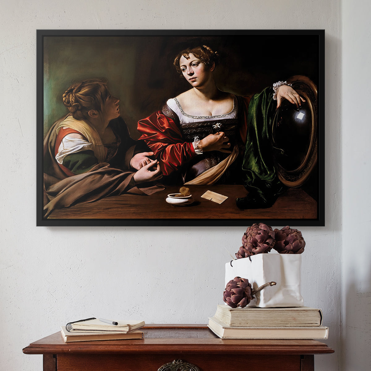 Black floater framed canvas featuring Martha and Mary Magdalene, c. 1598 by Caravaggio above an entryway table in a minimalist foyer.