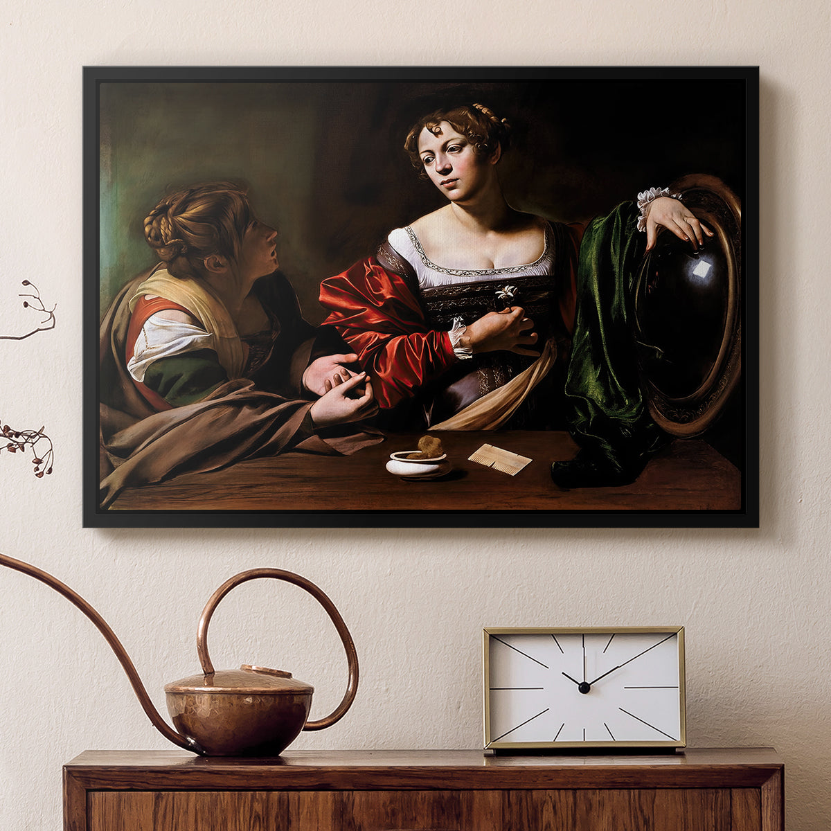 Black floater framed canvas featuring an intimate interaction between two women with mirror and objects, displayed above a cabinet in a soft-toned living room.