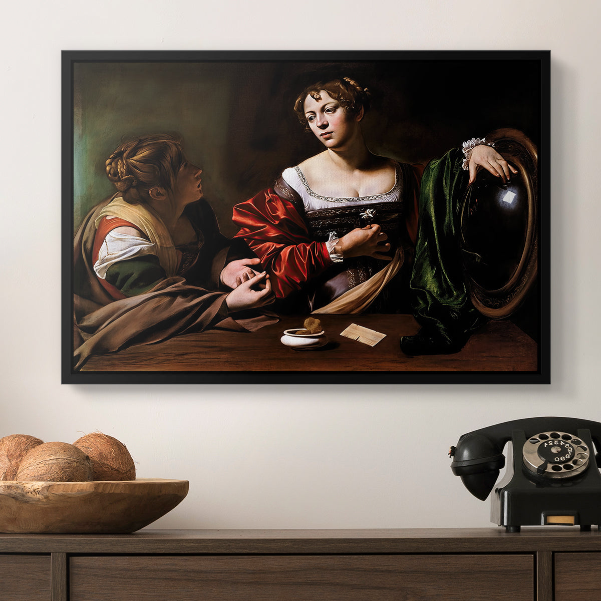 Martha and Mary Magdalene, c. 1598 by Caravaggio in a black floater framed canvas displayed above a console table in a hallway, featuring a religious interior scene with figures engaged in thoughtful dialogue.
