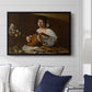 The Lute Player (Hermitage Version), c. 1596 by Caravaggio displayed above a sofa in a living room in a black floater frame, featuring a portrait of lute player surrounded by still life arrangement.