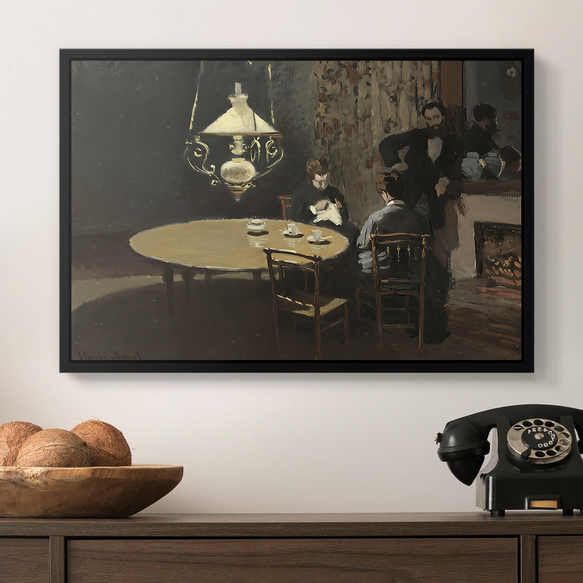Interior, after Dinner, 1868-1869 by Claude Monet in a black floater framed canvas displayed above a console table in a hallway, featuring an intimate indoor scene with figure and table in low lighting.