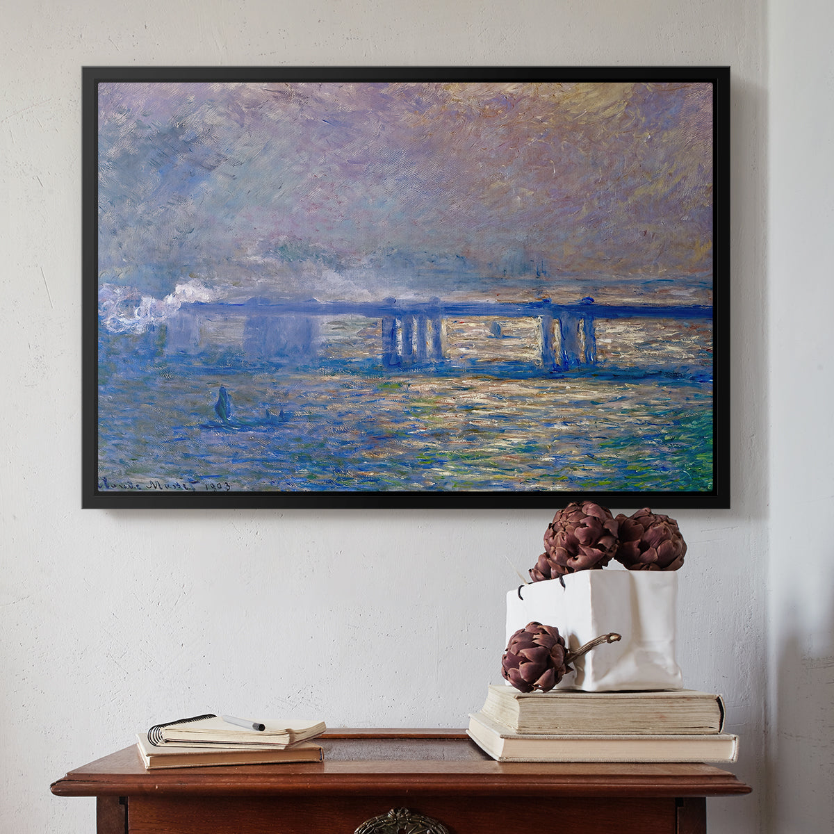 Black floater framed canvas featuring Charing Cross Bridge, 1903 by Claude Monet above an entryway table in a minimalist foyer.