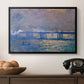 Charing Cross Bridge, 1903 by Claude Monet in a black floater framed canvas displayed above a console table in a hallway, featuring a city bridge scene softened by mist and impressionist brushwork.