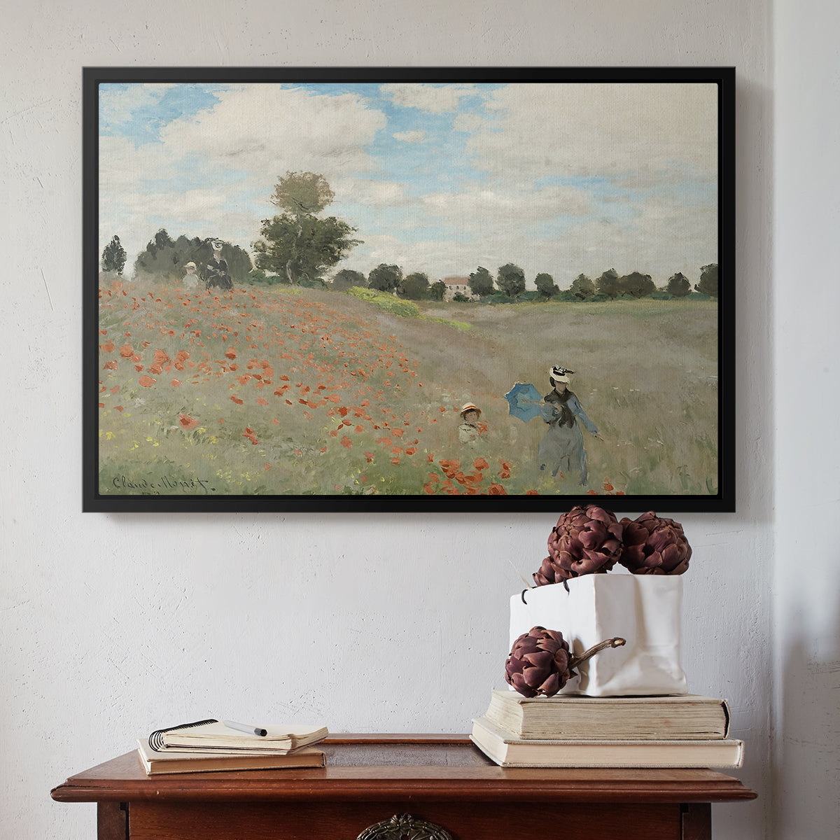 Black floater framed canvas featuring The Poppy Field near Argenteuil, 1873 by Claude Monet above an entryway table in a minimalist foyer.