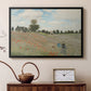 Black floater framed canvas featuring a bright meadow filled with poppies under open sky, displayed above a cabinet in a soft-toned living room.