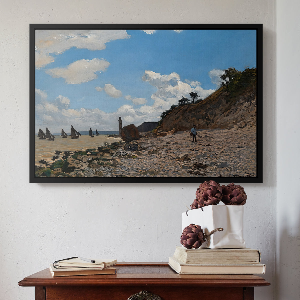 Black floater framed canvas featuring The Beach at Honfleur, 1864 by Claude Monet above an entryway table in a minimalist foyer.