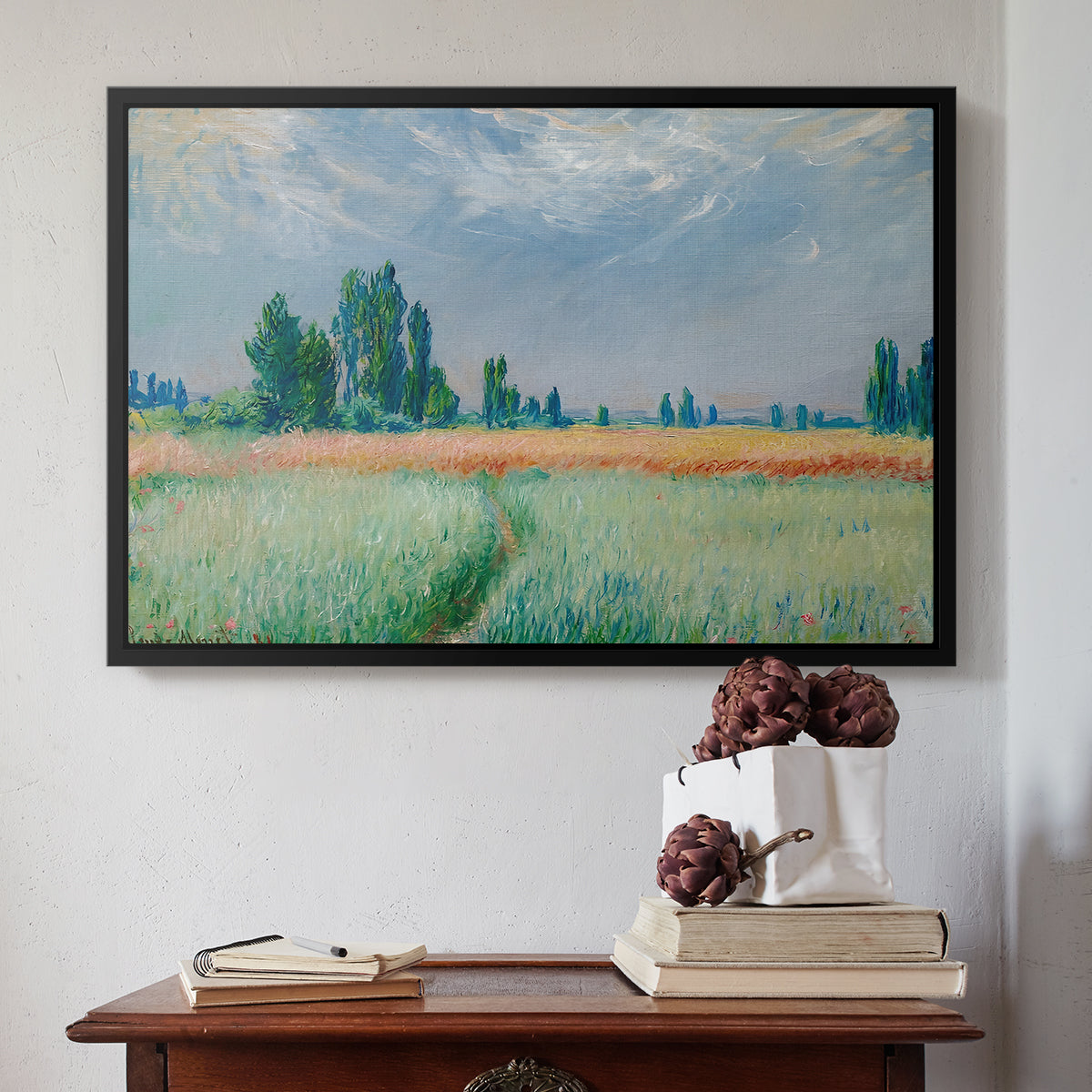 Black floater framed canvas featuring The Wheat Field (Champ de Blé), 1881 by Claude Monet above an entryway table in a minimalist foyer.