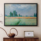 Black floater framed canvas featuring an agricultural landscape with tall wheat and distant horizon, displayed above a cabinet in a soft-toned living room.