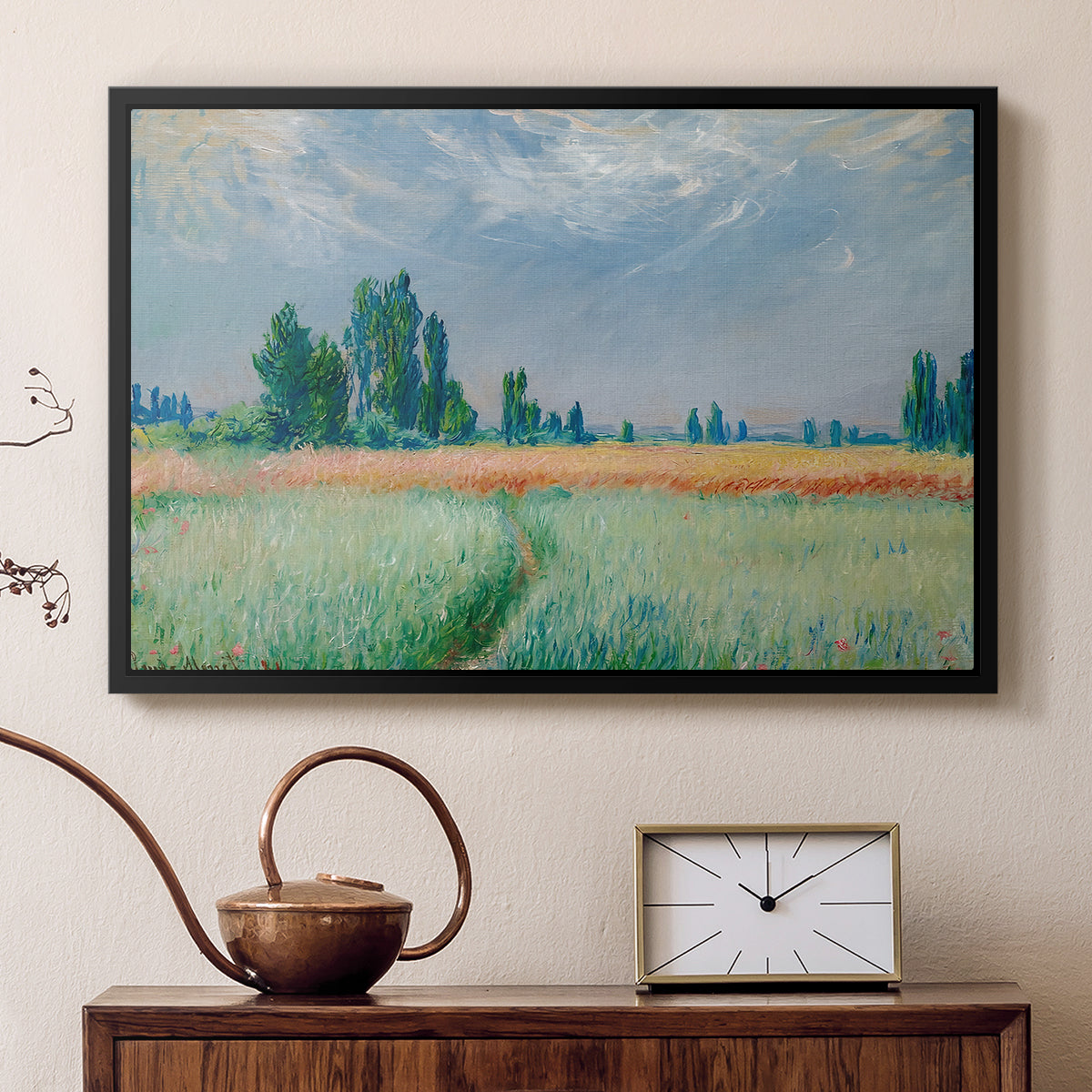 Black floater framed canvas featuring an agricultural landscape with tall wheat and distant horizon, displayed above a cabinet in a soft-toned living room.