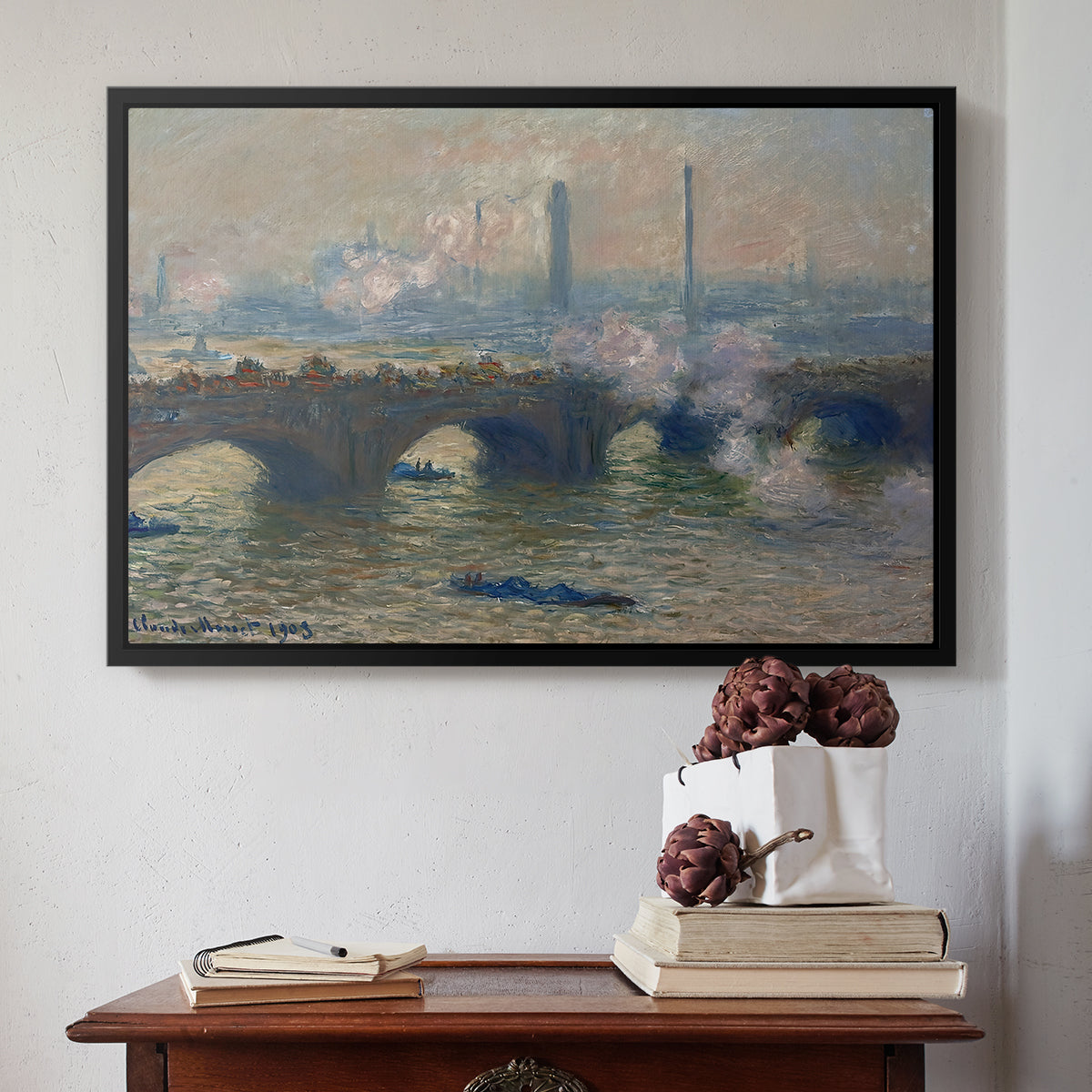 Black floater framed canvas featuring Waterloo Bridge, Gray Day, 1903 by Claude Monet above an entryway table in a minimalist foyer.