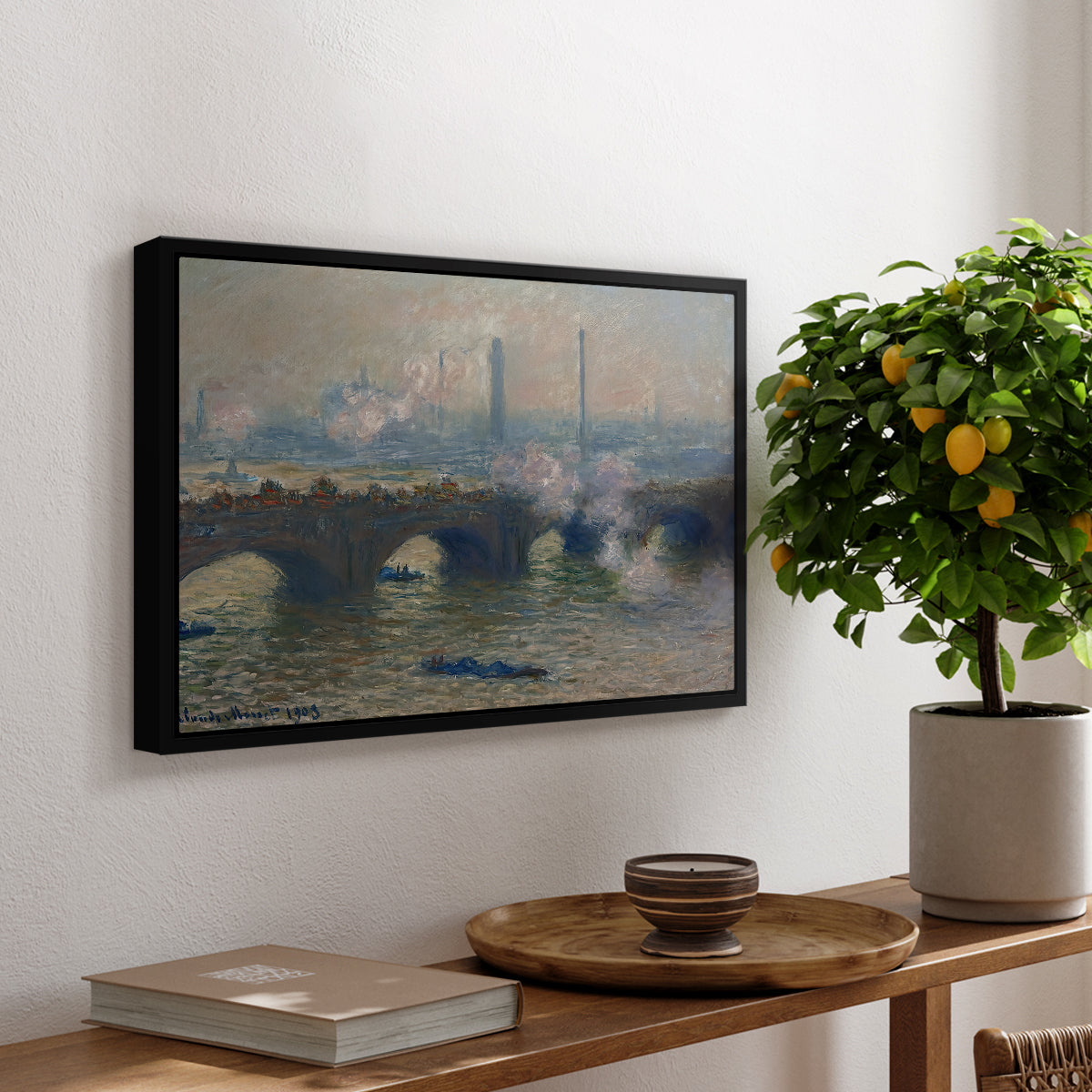 Waterloo Bridge, Gray Day, 1903 by Claude Monet, presented in a black floater framed canvas featuring a muted cityscape of bridge spanning river under overcast sky, displayed above a hallway console table.