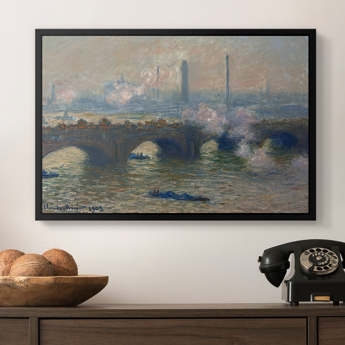 Waterloo Bridge, Gray Day, 1903 by Claude Monet in a black floater framed canvas displayed above a console table in a hallway, featuring a foggy London bridge view with softened architectural forms.