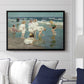 A Holiday, c. 1915 by Edward Henry Potthast displayed above a sofa in a living room in a black floater frame, featuring a beach scene with figures bathing and standing in waves under bright sky.
