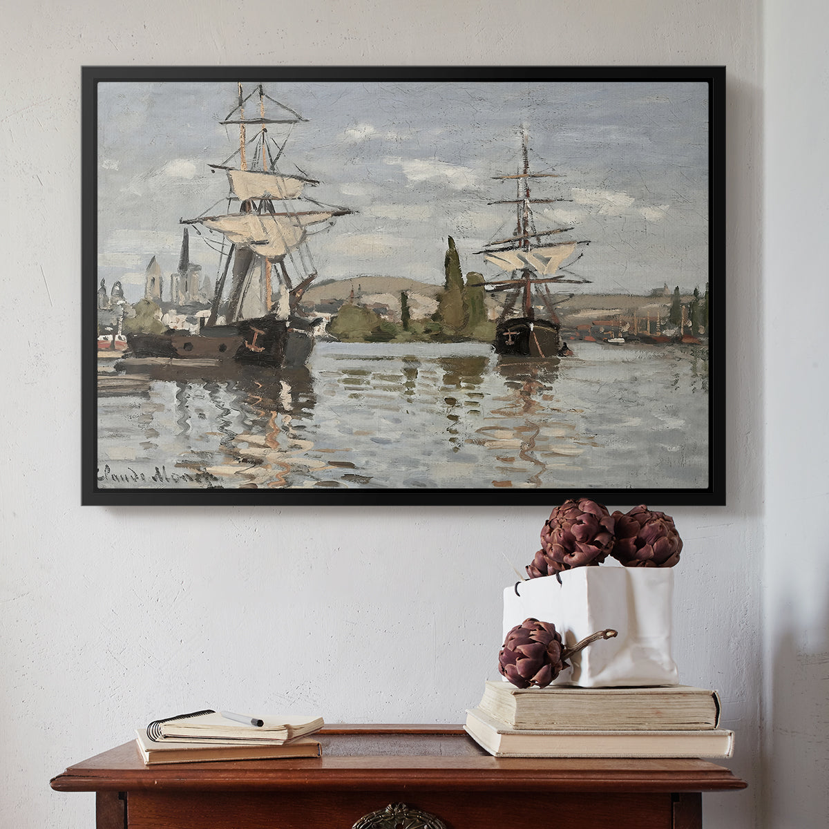 Black floater framed canvas featuring Ships Riding on the Seine at Rouen, 1872 by Claude Monet above an entryway table in a minimalist foyer.