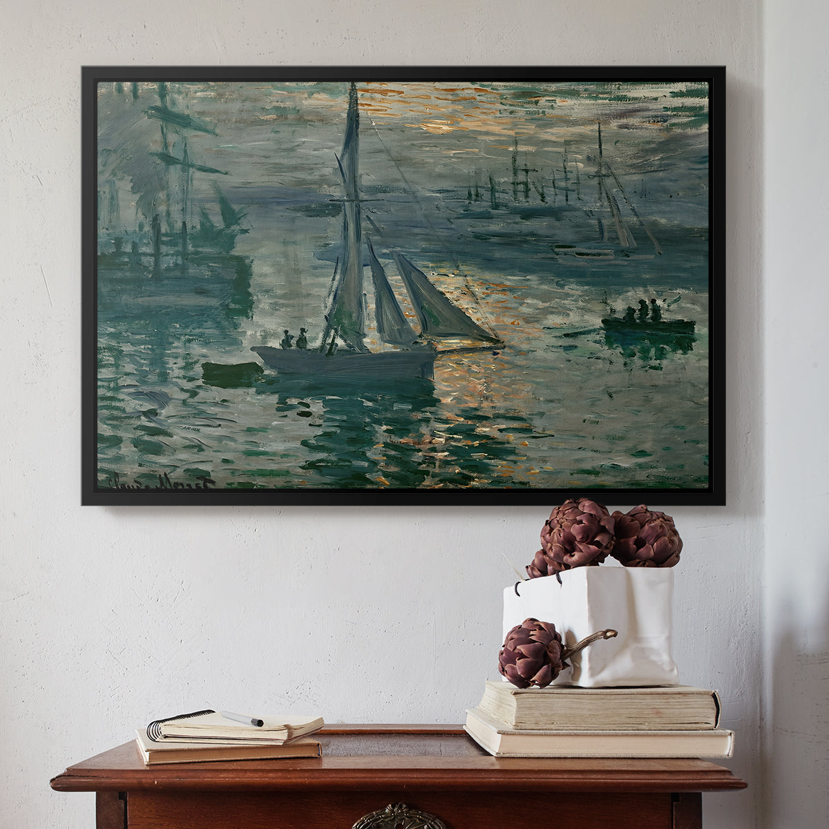 Black floater framed canvas featuring Sunrise (Marine), 1873 by Claude Monet above an entryway table in a minimalist foyer.