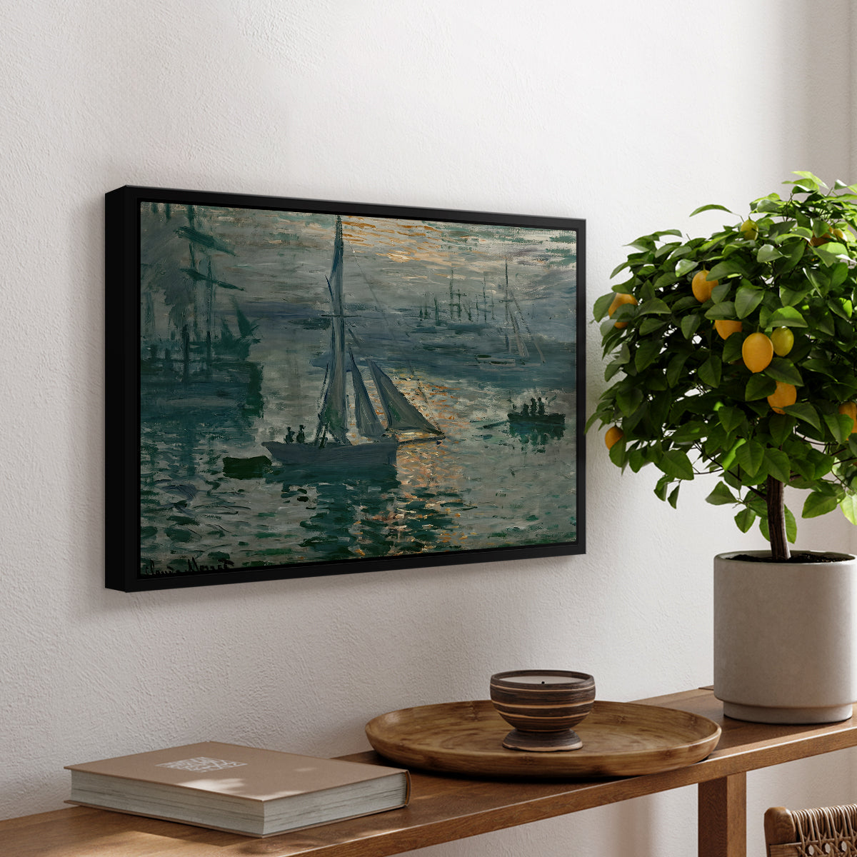 Sunrise (Marine), 1873 by Claude Monet, presented in a black floater framed canvas featuring a hazy sunrise over harbor with boats silhouetted in soft morning light, displayed above a hallway console table.