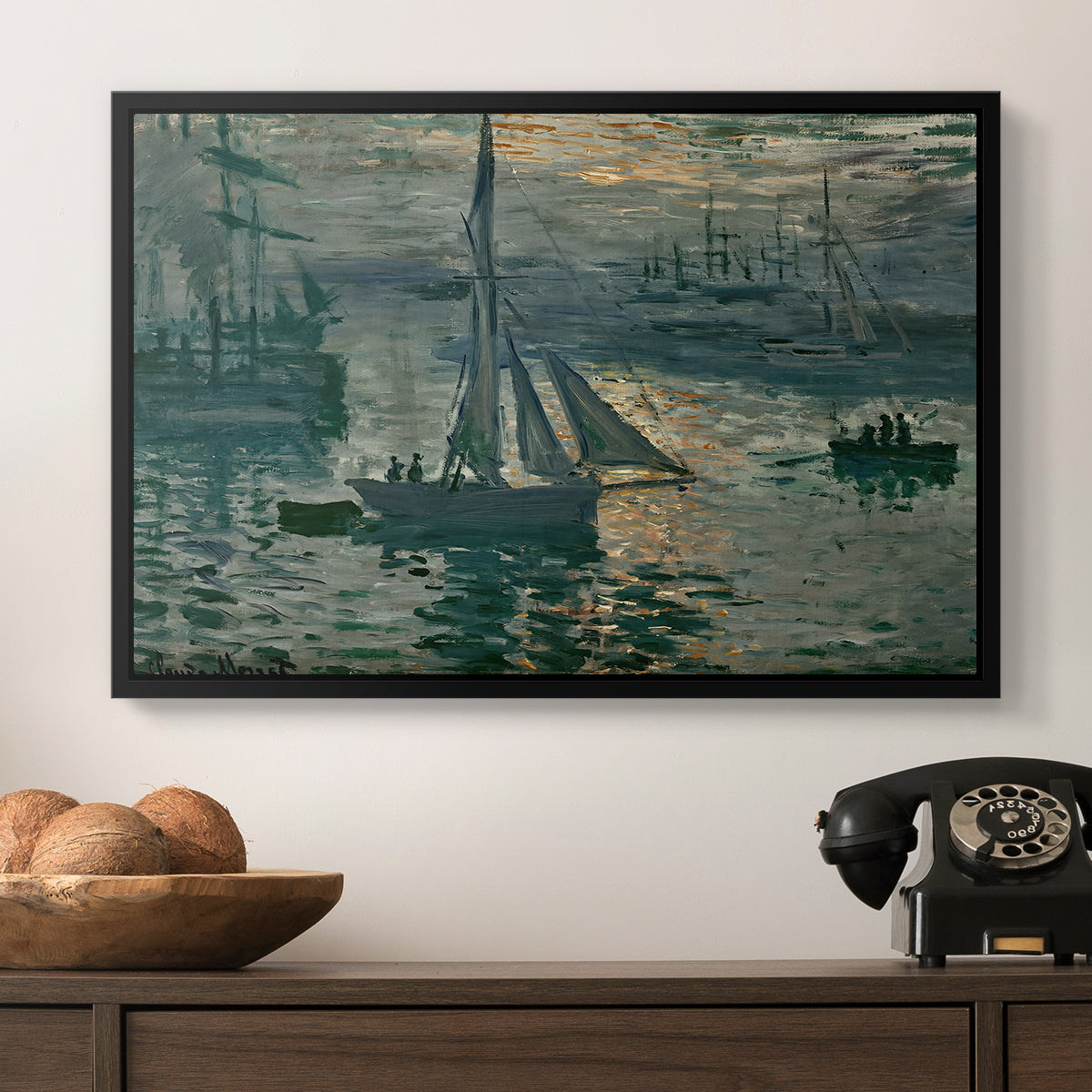 Sunrise (Marine), 1873 by Claude Monet in a black floater framed canvas displayed above a console table in a hallway, featuring an atmospheric ocean view with sun rising through haze.