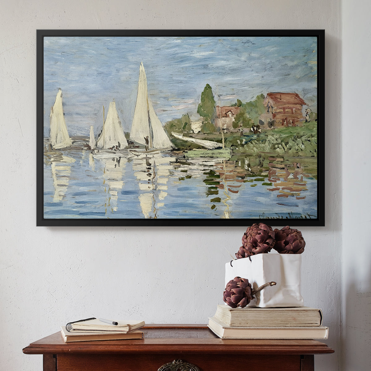 Black floater framed canvas featuring Regatta at Argenteuil, 1872 by Claude Monet above an entryway table in a minimalist foyer.