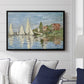 Regatta at Argenteuil, 1872 by Claude Monet displayed above a sofa in a living room in a black floater frame, featuring a lively regatta scene with multiple boats and fluttering sails.