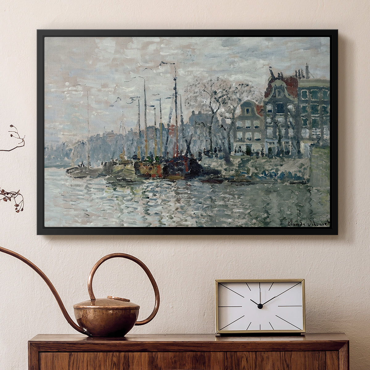 Black floater framed canvas featuring an urban waterway with docked boats and European buildings, displayed above a cabinet in a soft-toned living room.