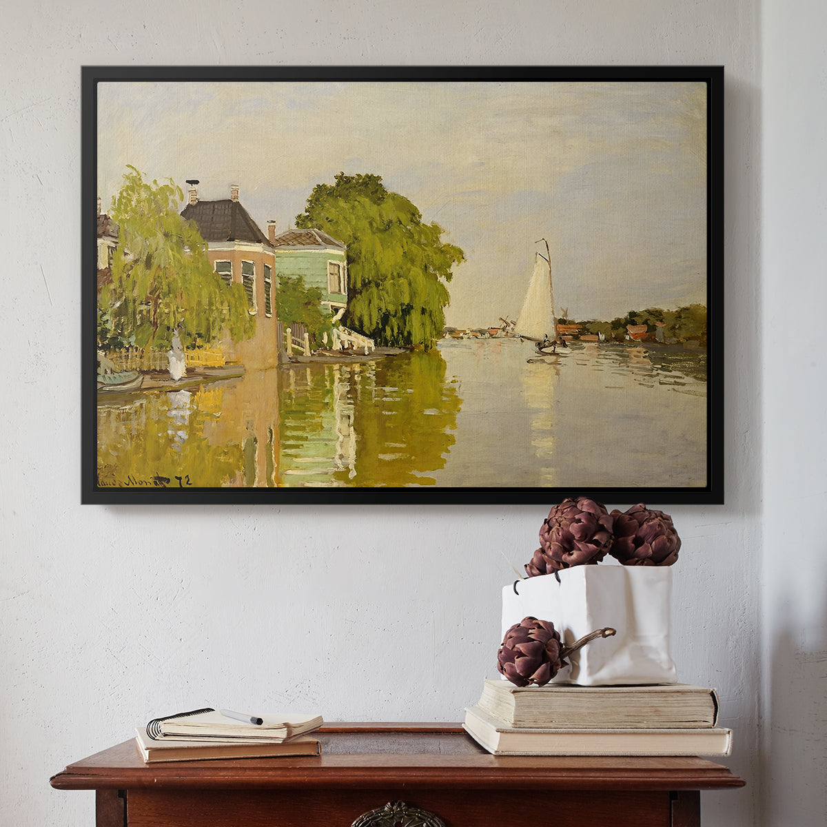 Black floater framed canvas featuring Houses on the Achterzaan, 1871 by Claude Monet above an entryway table in a minimalist foyer.