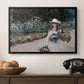 Young Girl in the Garden at Giverny, 1888 by Claude Monet in a black floater framed canvas displayed above a console table in a hallway, featuring a tranquil outdoor portrait of girl in floral setting.