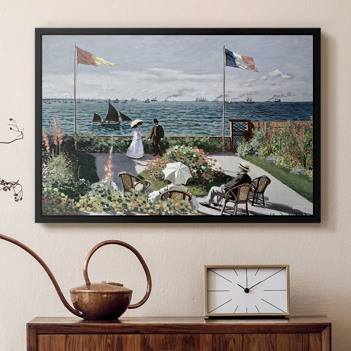 Black floater framed canvas featuring a vibrant garden scene with colorful blooms and distant sea, displayed above a cabinet in a soft-toned living room.