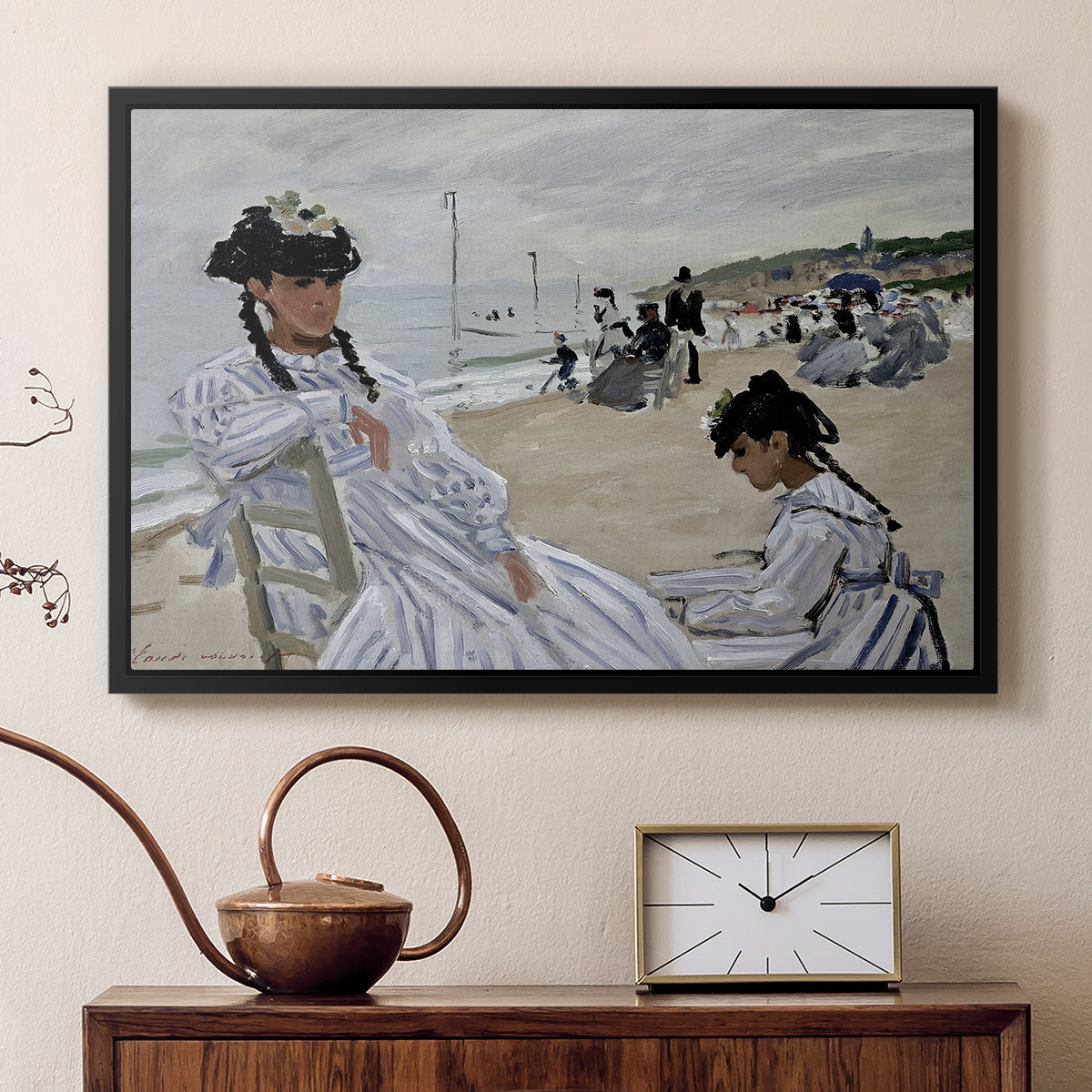 Black floater framed canvas featuring a beach setting with people relaxing under umbrellas, displayed above a cabinet in a soft-toned living room.