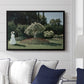 Woman in the Garden, Sainte-Adresse, 1867 by Claude Monet displayed above a sofa in a living room in a black floater frame, featuring an impressionist figure in sunlit garden with lush vegetation.