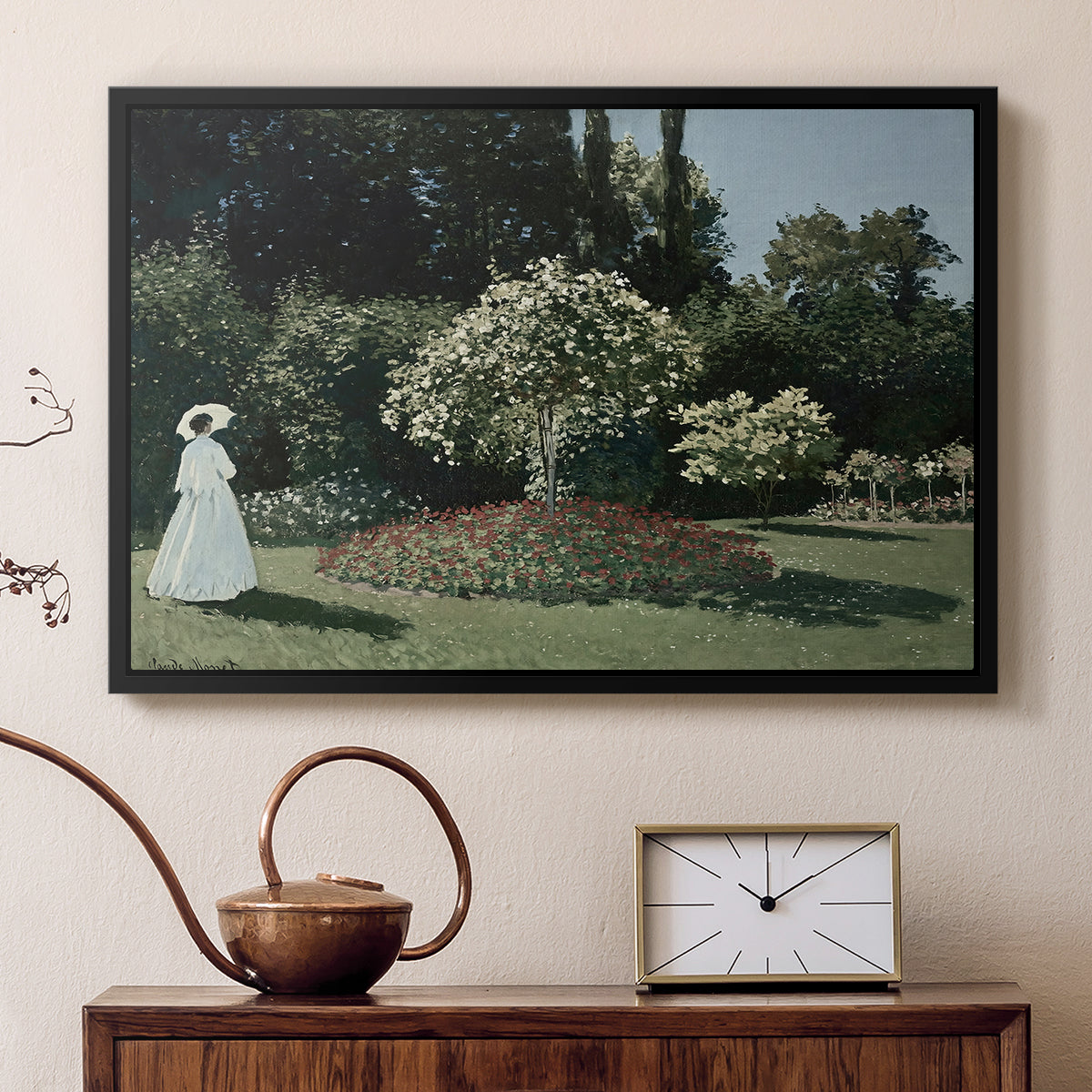Black floater framed canvas featuring an elegant woman posed outdoors among blooming plants, displayed above a cabinet in a soft-toned living room.
