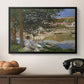 On the Bank of the Seine, Bennecourt, 1868 by Claude Monet in a black floater framed canvas displayed above a console table in a hallway, featuring a quiet outdoor setting with figures near river under foliage.