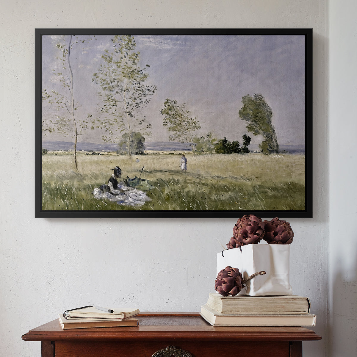 Black floater framed canvas featuring Summer (L'ete), 1874 by Claude Monet above an entryway table in a minimalist foyer.