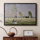 Black floater framed canvas featuring a sunlit meadow with woman surrounded by greenery, displayed above a cabinet in a soft-toned living room.
