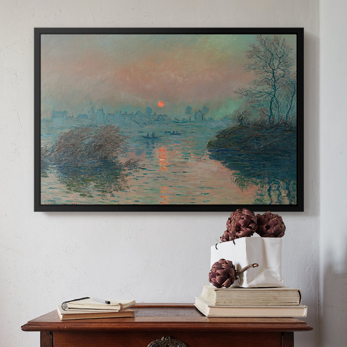 Black floater framed canvas featuring Sunset on the Seine at Lavacourt, Winter Effect, 1880 by Claude Monet above an entryway table in a minimalist foyer.