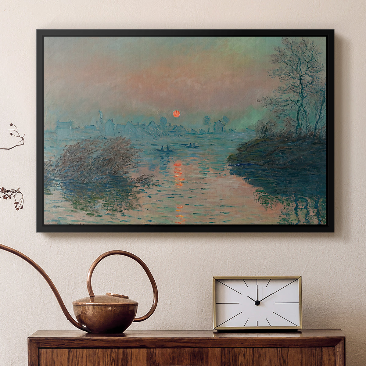 Black floater framed canvas featuring an impressionist view of river at sunset with snowy banks, displayed above a cabinet in a soft-toned living room.